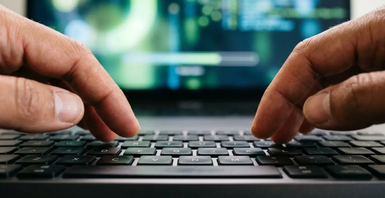 Close-up of hands configuring an automated payroll system with abstract data visualizations on screen