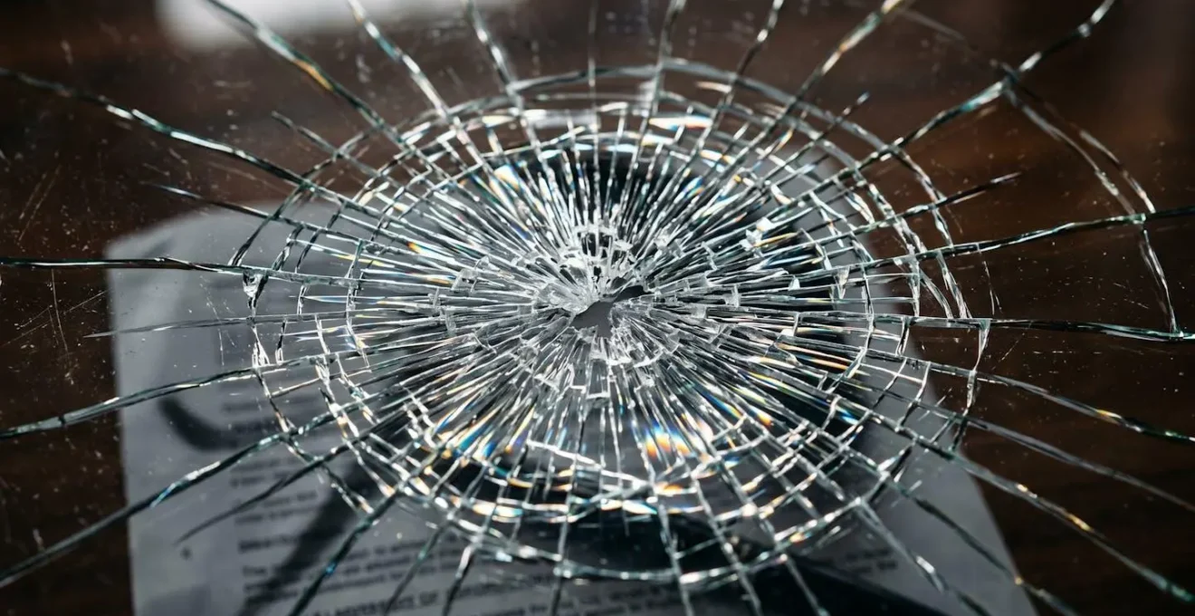 Close-up of legal documents with broken glass effect symbolizing corporate veil piercing