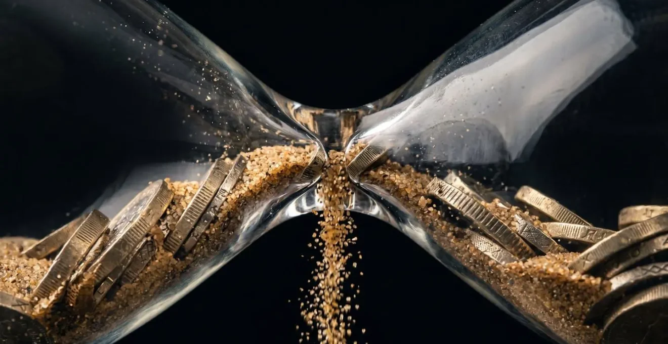 Hourglass with British pound coins falling through representing time-sensitive tax obligations